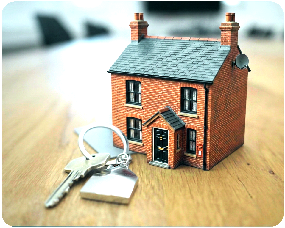 Miniature UK brick house model with keys